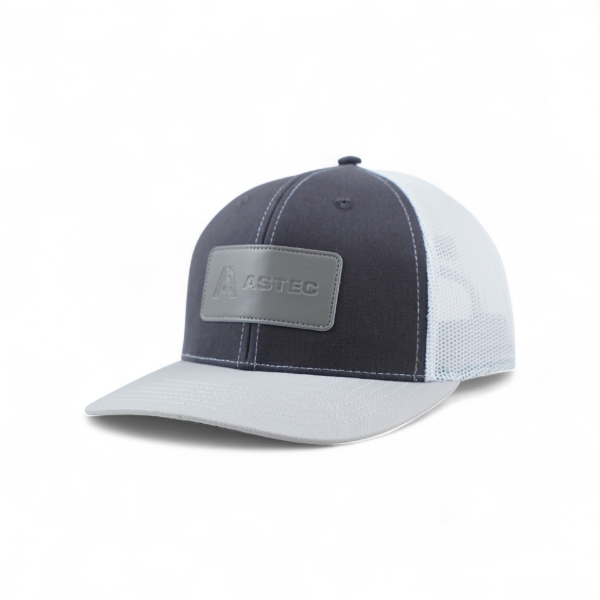 Right side view of Astec Rubber Patch Hat with structured navy front, gray bill, and mesh back